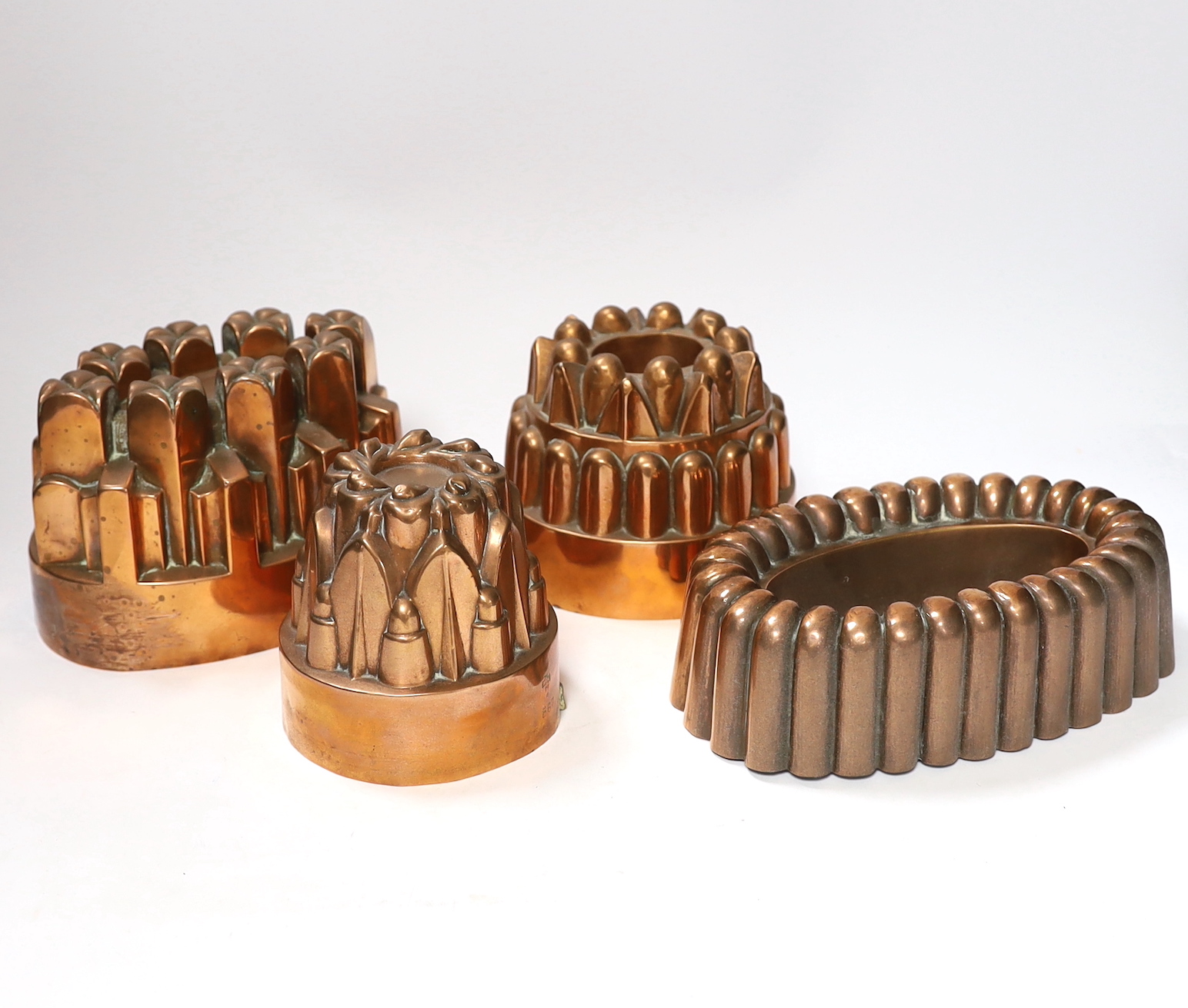 Four Victorian copper jelly moulds, one stamped with Benham & Froud mark and ‘Temple & Crook Ironmongers’